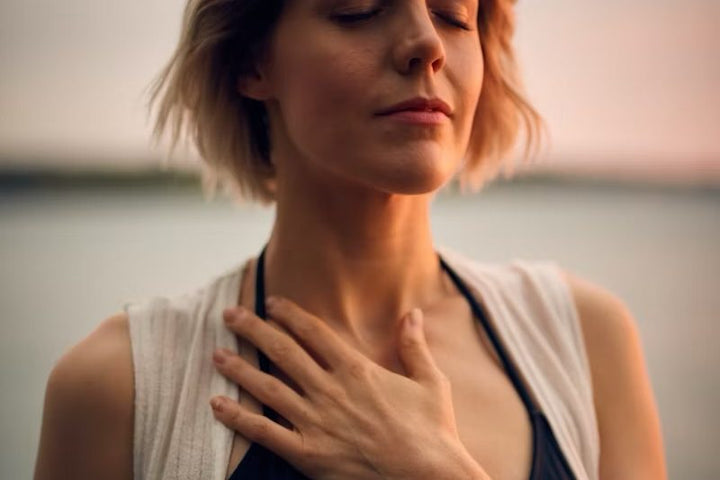 A calm breath, one hand resting on the chest