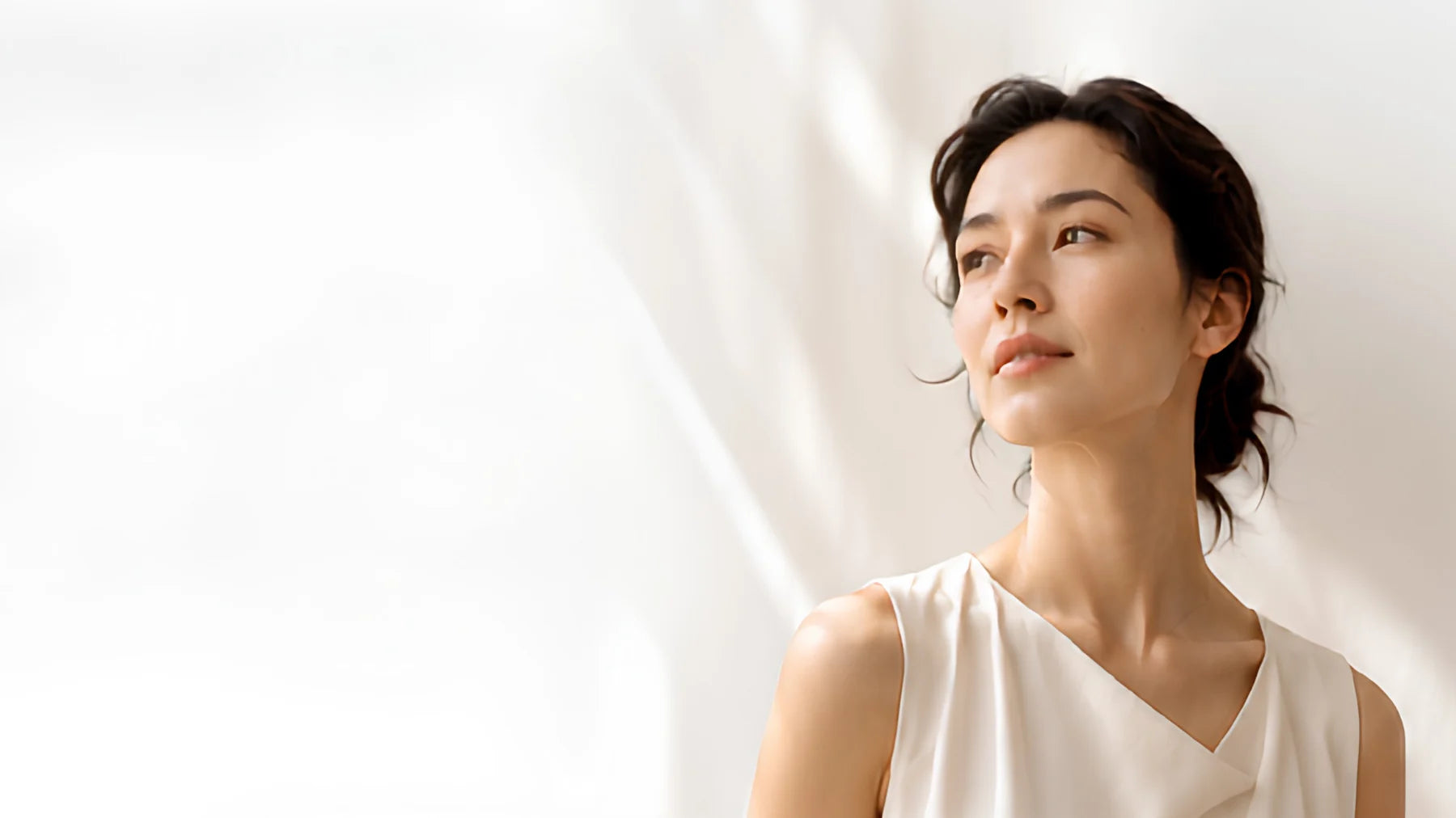 A woman in soft daylight, turned toward the light